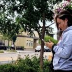 Woman standing looking at cell phone